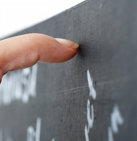 Vinger wijst naar woord op schoolbord,symbool voor uitleg over misofonie en sterke emotionele reacties op geluid.